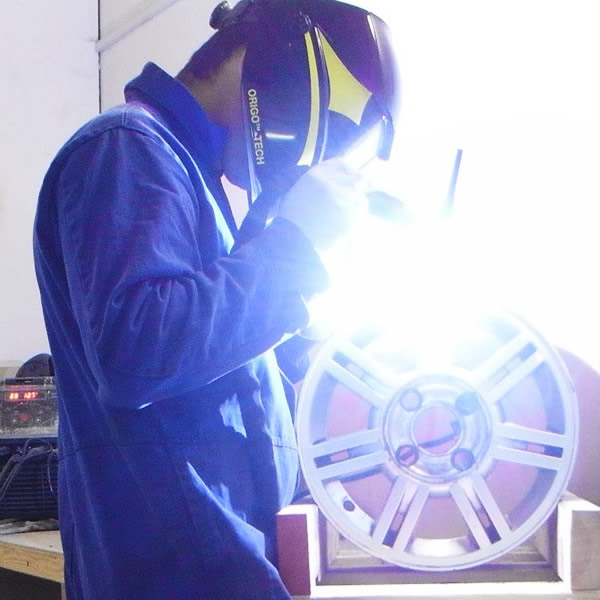 Alloy wheel being welded